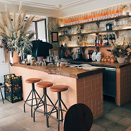 Image of cozy Cafe bar in warm colors and full shelfs